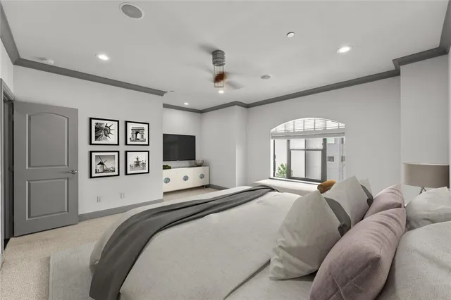 a bedroom with a large bed and a flat screen tv