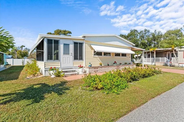 a front view of a house with a yard table and chairs