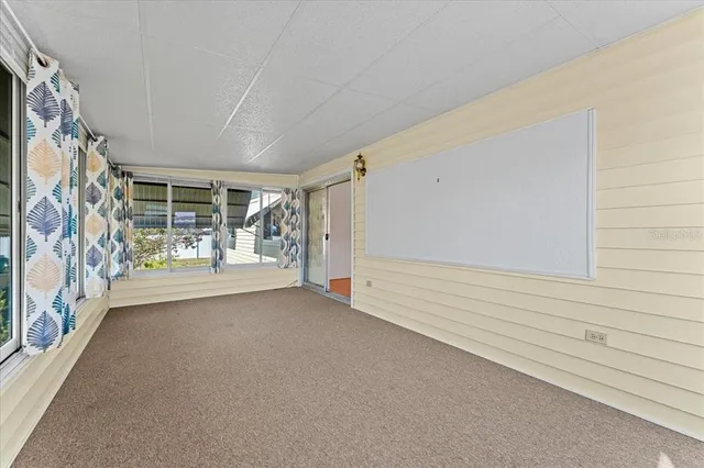 a view of a dining room with furniture a potted plant and wooden floor