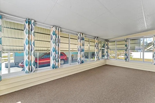 a view of a kitchen with stainless steel appliances kitchen island granite countertop a dishwasher a stove a refrigerator and white cabinets with wooden floor