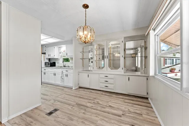 a view of a room with cabinet and chandelier