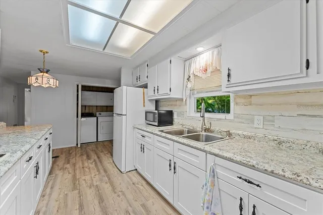 a kitchen with stainless steel appliances granite countertop a stove a refrigerator and a microwave