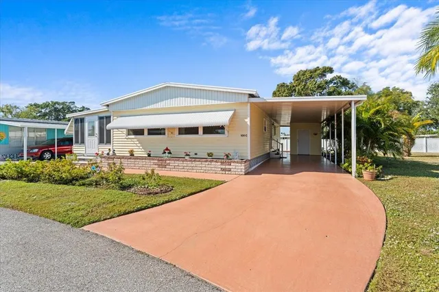 a view of a house with backyard porch and sitting area