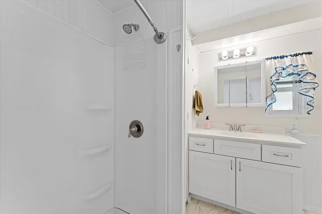 a bathroom with a glass shower door