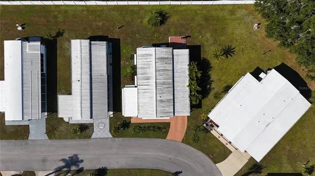 an aerial view of a residential apartment building with a yard