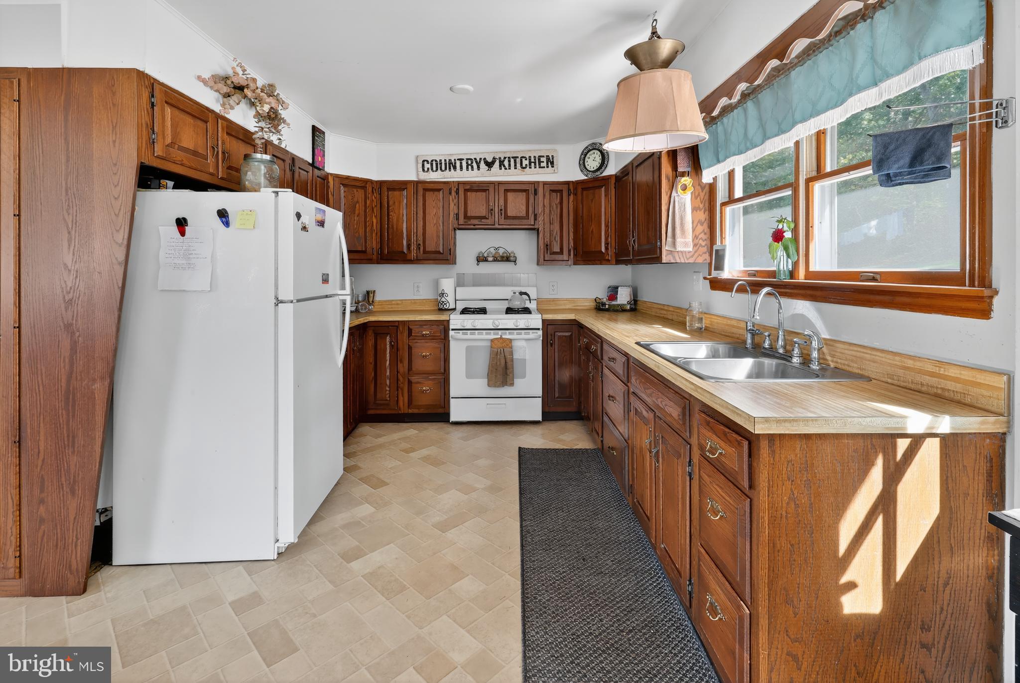 1201 Spruce Grove Road Oxford, PA 19363 - Photo 20 of 32 a kitchen with stainless steel appliances granite countertop a sink stove and refrigerator