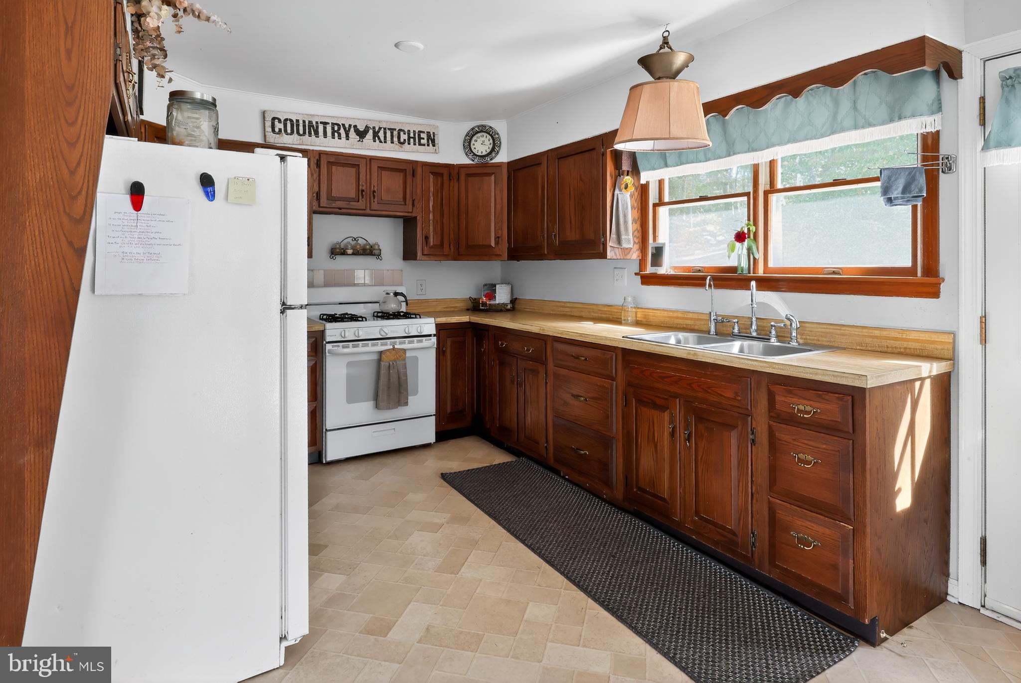 1201 Spruce Grove Road Oxford, PA 19363 - Photo 22 of 32 a kitchen with stainless steel appliances granite countertop a sink stove and refrigerator
