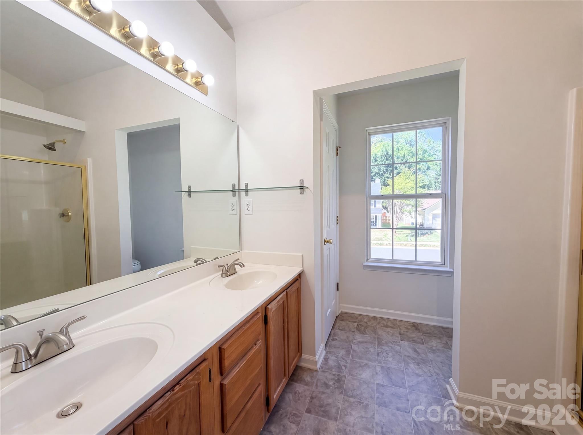 7423 Henderson Park Road Huntersville, NC 28078 - Photo 11 of 16 a spacious bathroom with a double vanity sink and a mirror