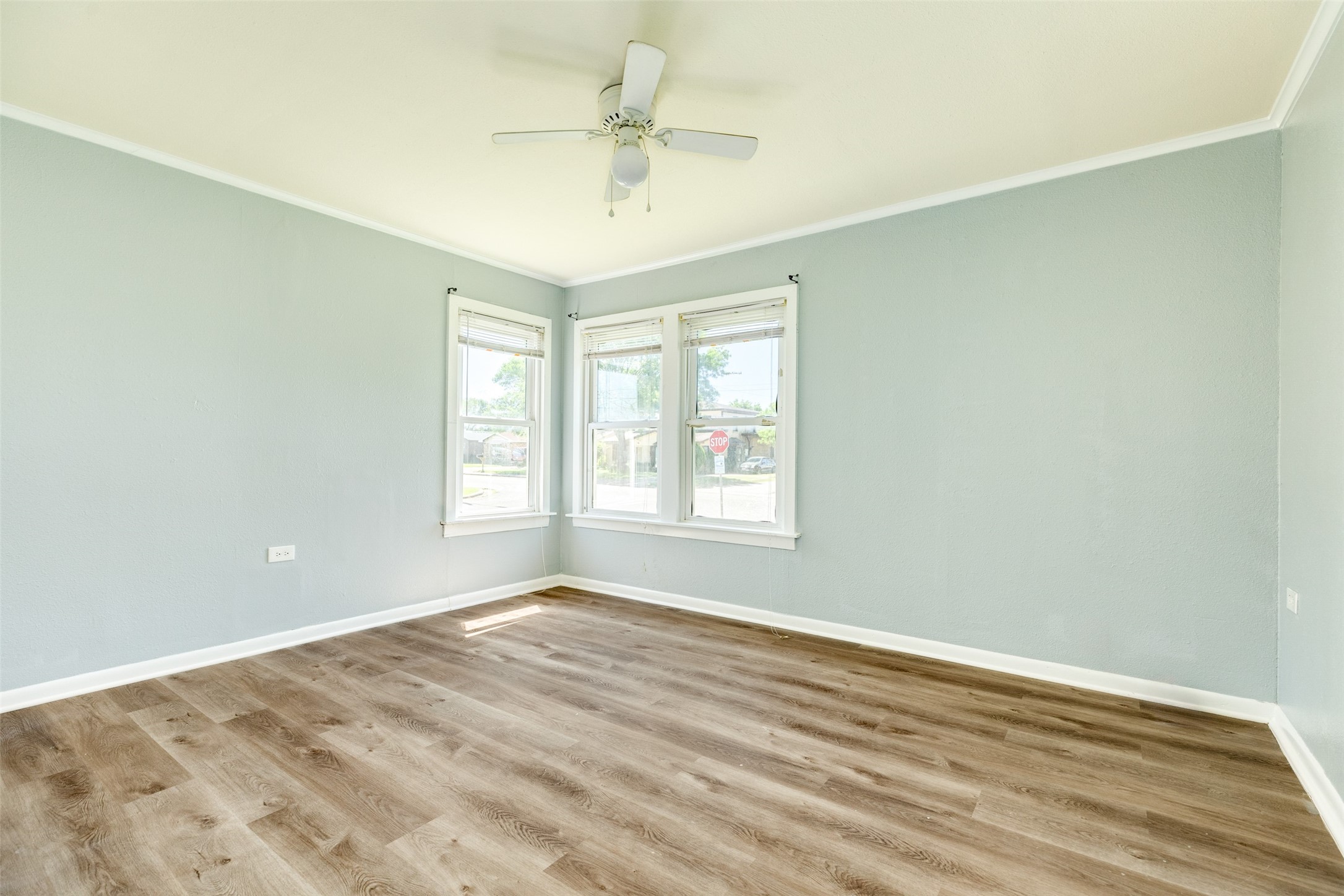 302 West 8th Street, Unit A Freeport, TX 77541 - Photo 13 of 25 wooden floor in an empty room with a window