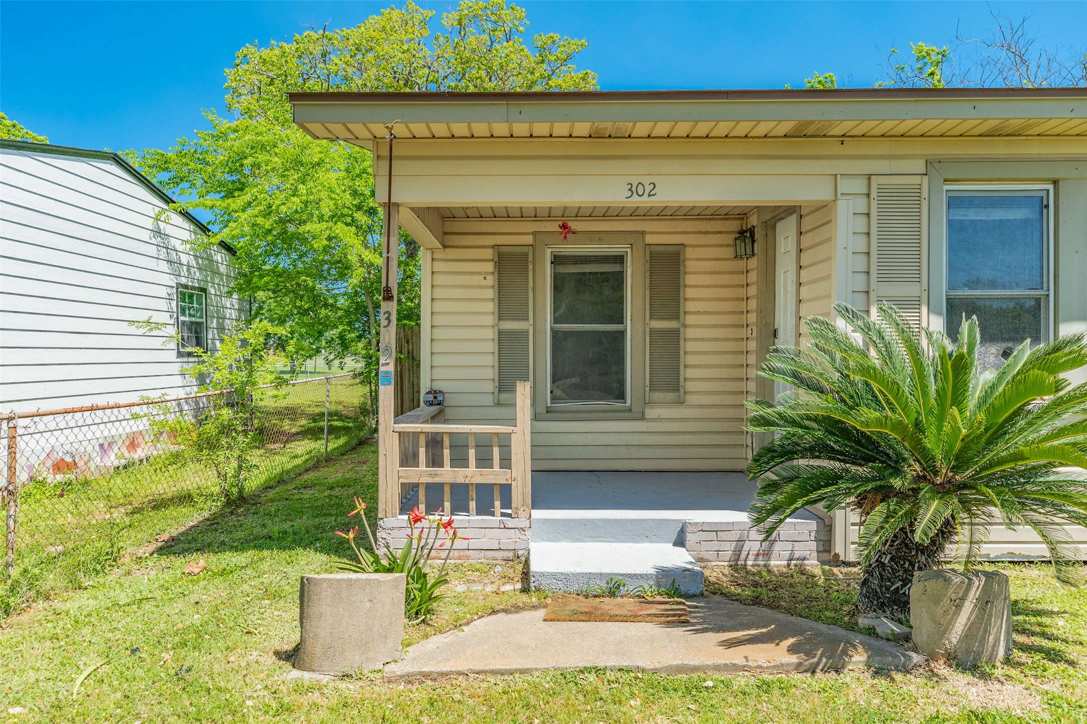 302 West 8th Street, Unit A Freeport, TX 77541 - Photo 20 of 25 a front view of a house with garden
