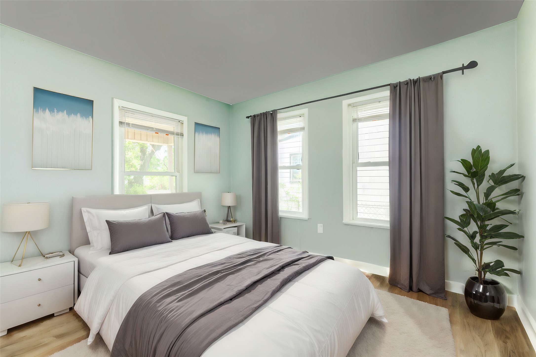 302 West 8th Street, Unit A Freeport, TX 77541 - Photo 25 of 25 a bedroom with a bed and a potted plant next to a window