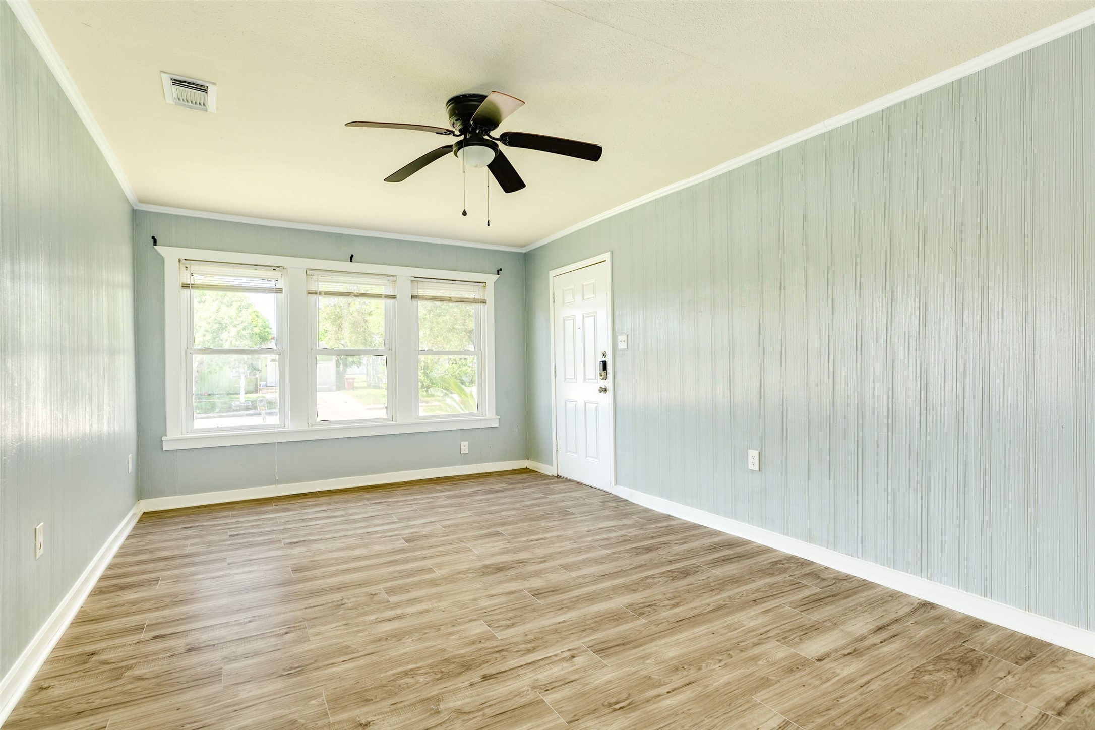 302 West 8th Street, Unit A Freeport, TX 77541 - Photo 3 of 25 a view of empty room with wooden floor and fan
