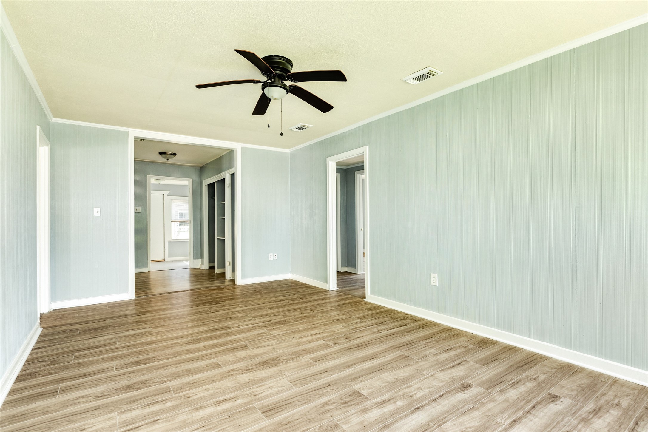 302 West 8th Street, Unit A Freeport, TX 77541 - Photo 5 of 25 a view of empty room with wooden floor and fan