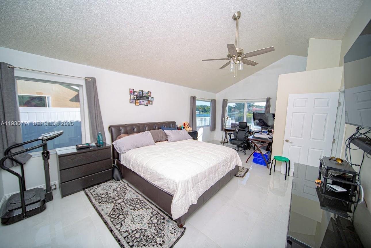 13020 Southwest 17th Court Miramar, FL 33027 - Photo 12 of 78 a bed room with a bed window and a ceiling fan