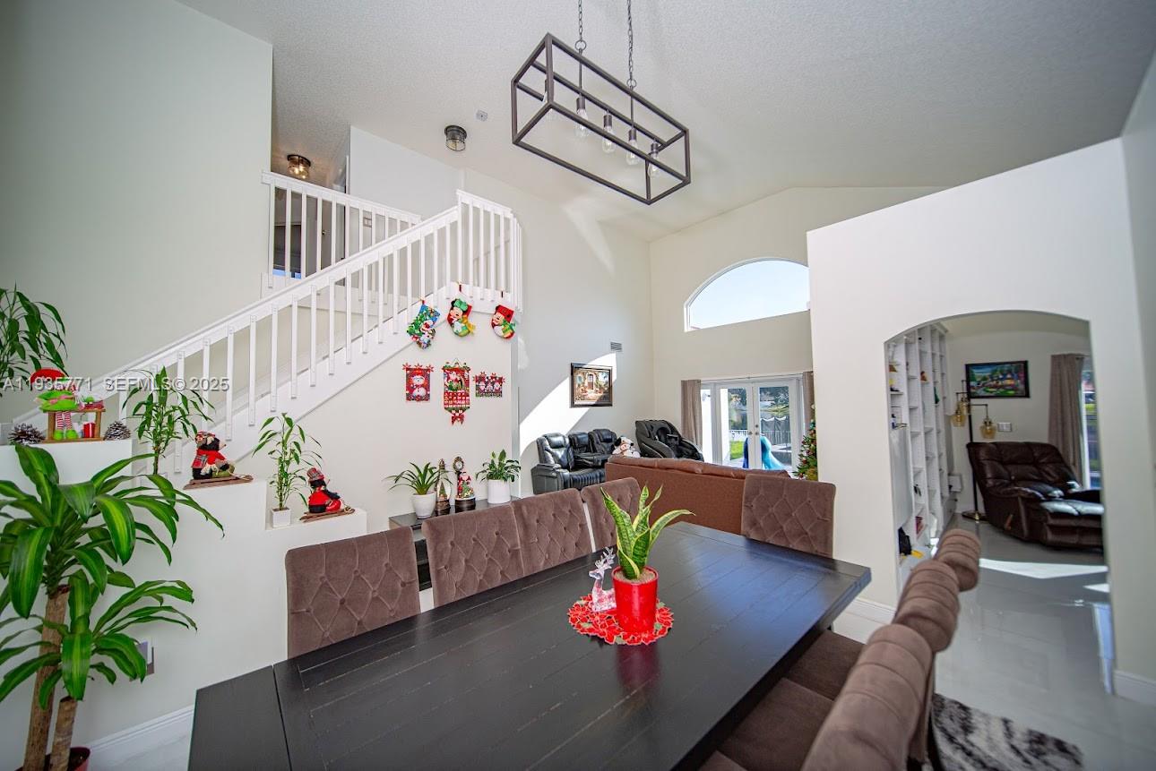 13020 Southwest 17th Court Miramar, FL 33027 - Photo 16 of 78 a living room with furniture and a chandelier