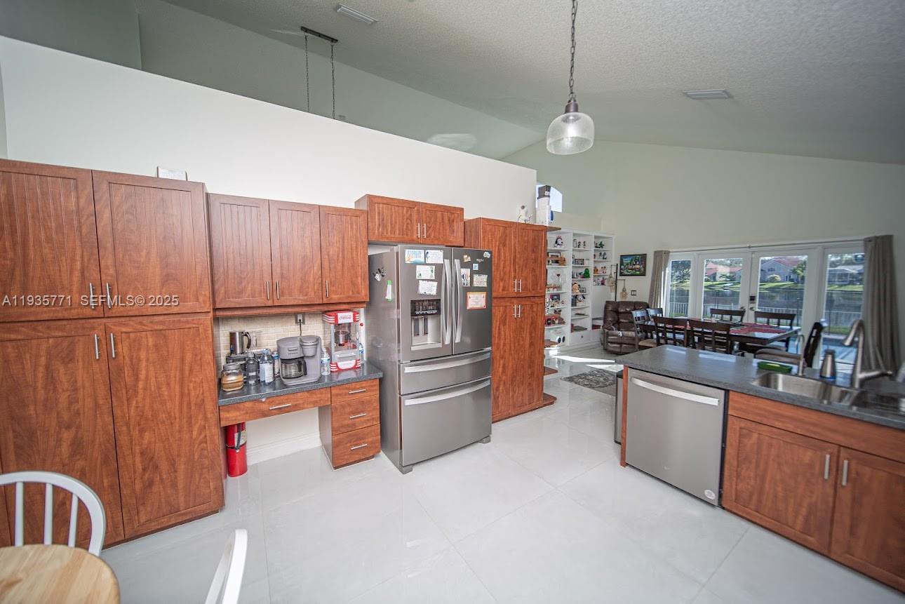 13020 Southwest 17th Court Miramar, FL 33027 - Photo 26 of 78 a kitchen with stainless steel appliances granite countertop a refrigerator a sink dishwasher and a stove