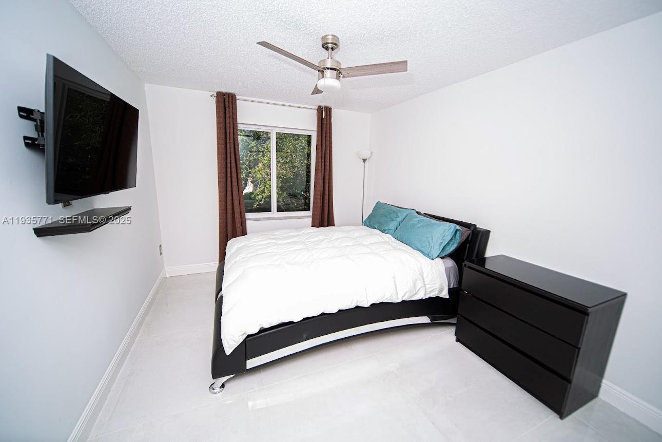 13020 Southwest 17th Court Miramar, FL 33027 - Photo 28 of 78 a spacious bedroom with a bed and a flat screen tv