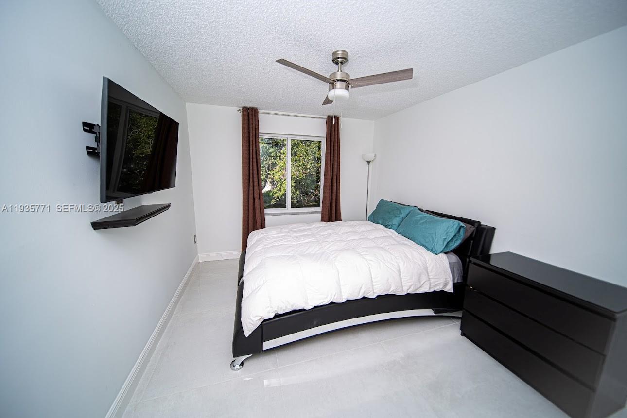 13020 Southwest 17th Court Miramar, FL 33027 - Photo 29 of 78 a bed sitting in a spacious bedroom next to a window