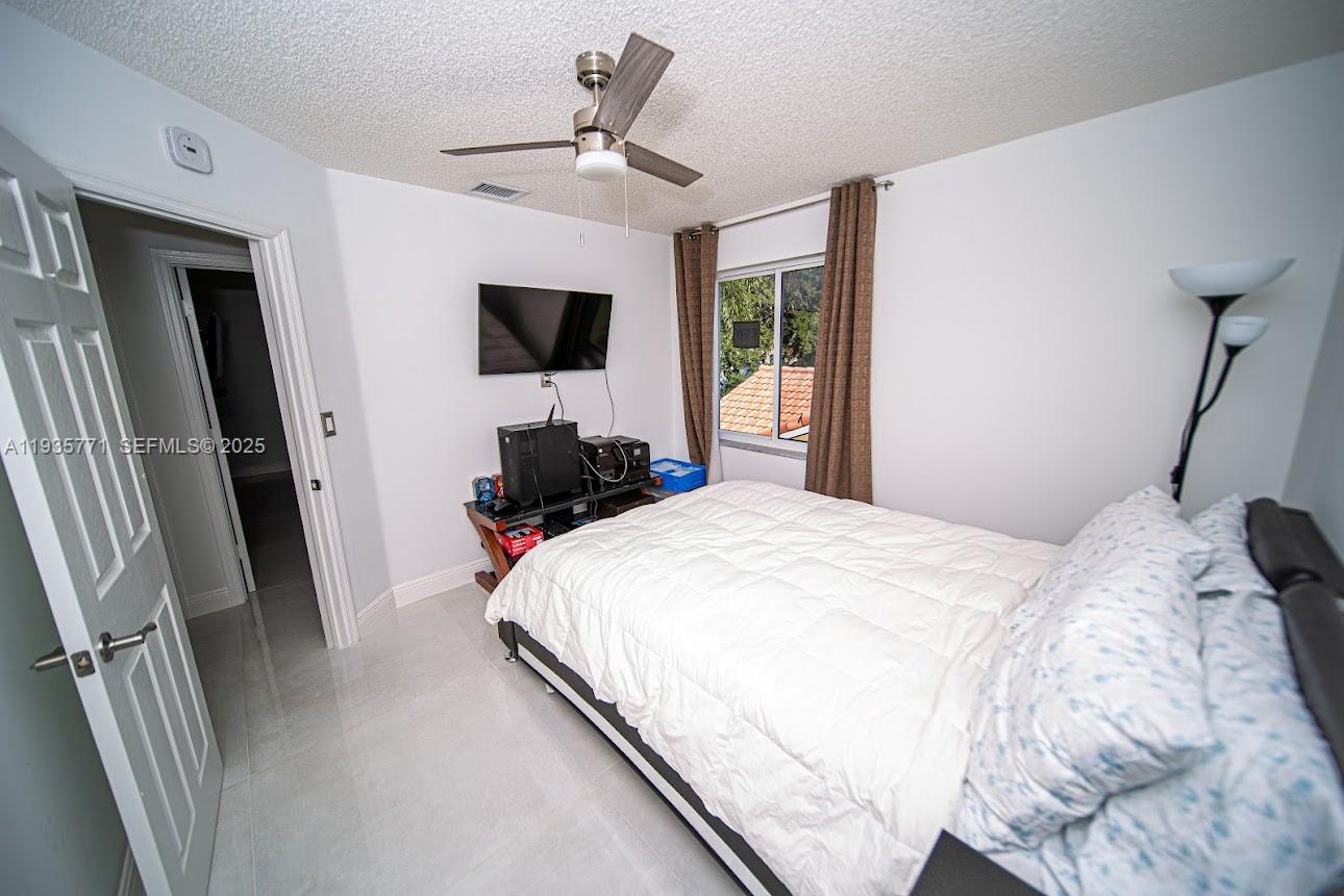 13020 Southwest 17th Court Miramar, FL 33027 - Photo 33 of 78 a bedroom with a bed and a flat screen tv