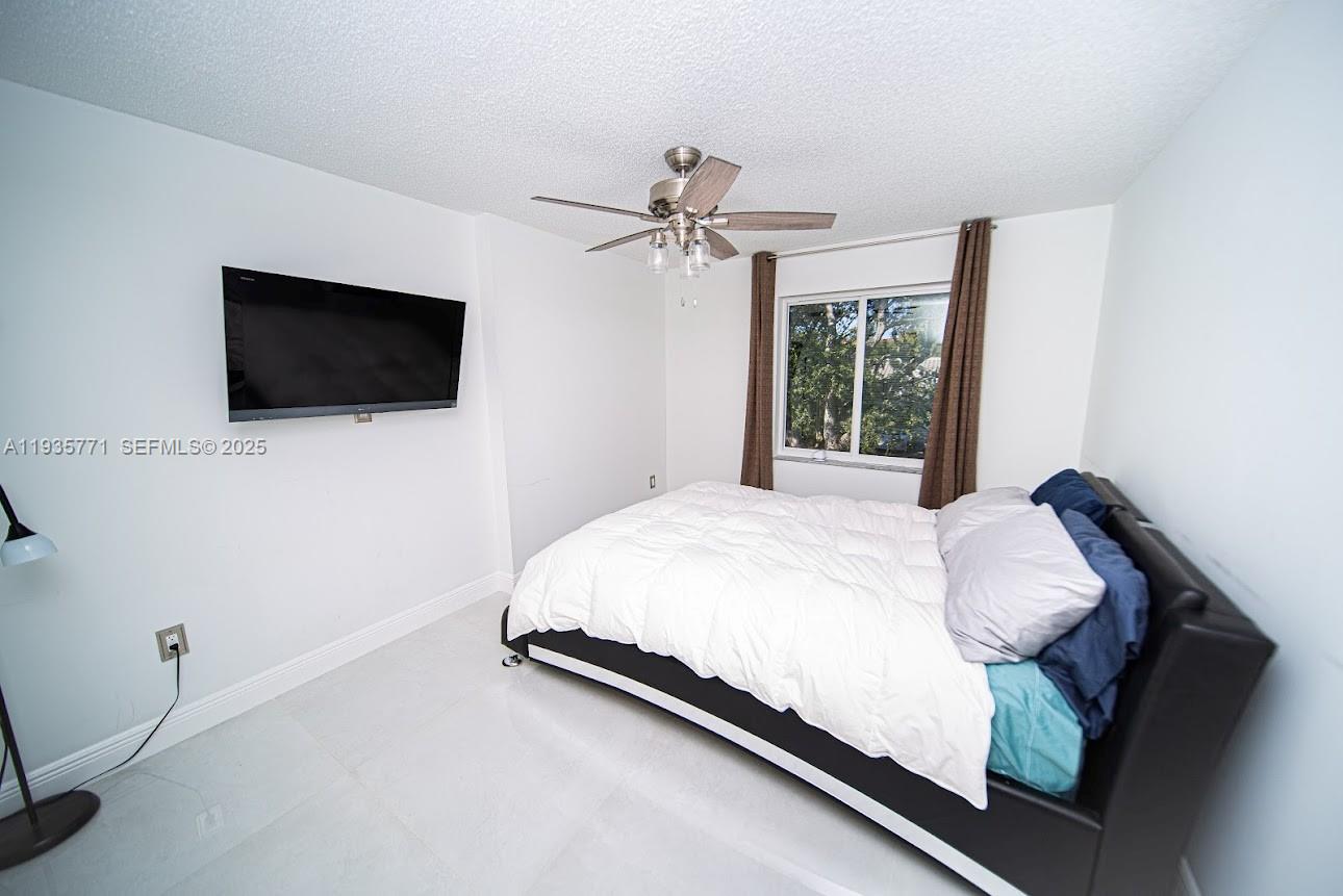 13020 Southwest 17th Court Miramar, FL 33027 - Photo 35 of 78 a bedroom with a bed and a flat screen tv