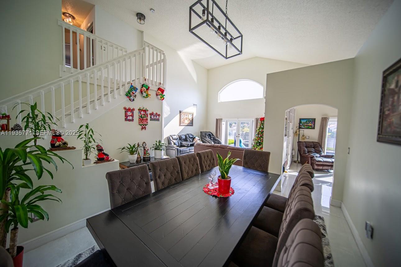 13020 Southwest 17th Court Miramar, FL 33027 - Photo 39 of 78 a living room with furniture and a chandelier
