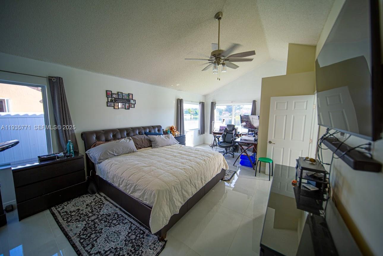 13020 Southwest 17th Court Miramar, FL 33027 - Photo 43 of 78 a bed room with a bed furniture and a flat tv screen