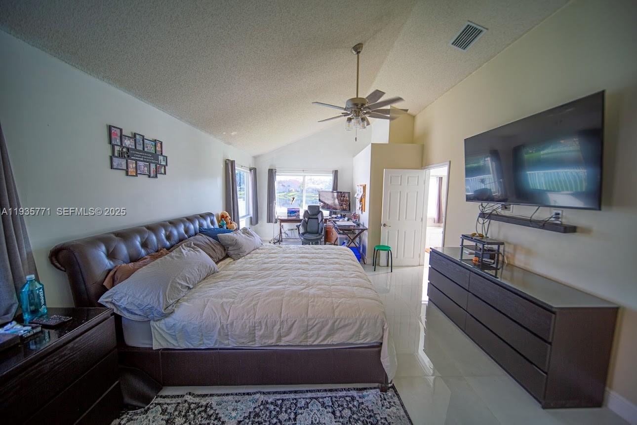 13020 Southwest 17th Court Miramar, FL 33027 - Photo 46 of 78 a bedroom with a bed and a flat screen tv