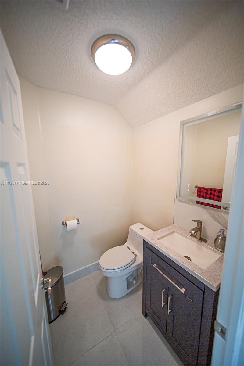 13020 Southwest 17th Court Miramar, FL 33027 - Photo 50 of 78 a bathroom with a double vanity sink toilet and a mirror
