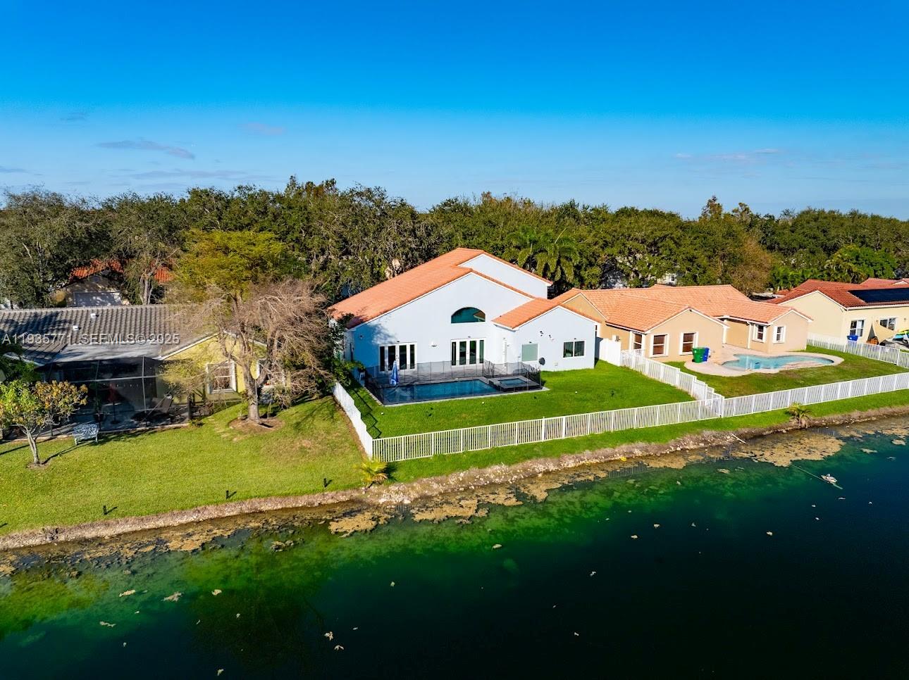 13020 Southwest 17th Court Miramar, FL 33027 - Photo 55 of 78 a view of an house with swimming pool and mountains in the background