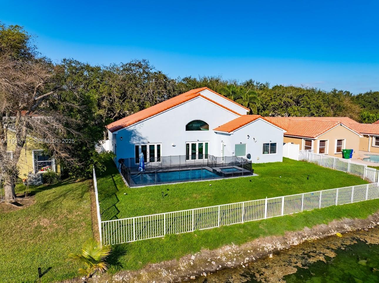 13020 Southwest 17th Court Miramar, FL 33027 - Photo 56 of 78 a view of a house with a big yard and potted plants