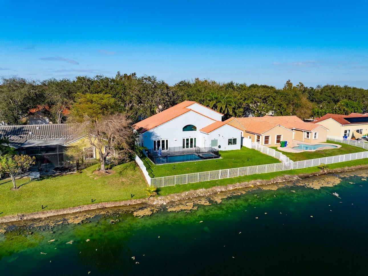 13020 Southwest 17th Court Miramar, FL 33027 - Photo 59 of 78 a view of an house with swimming pool and mountains in the background