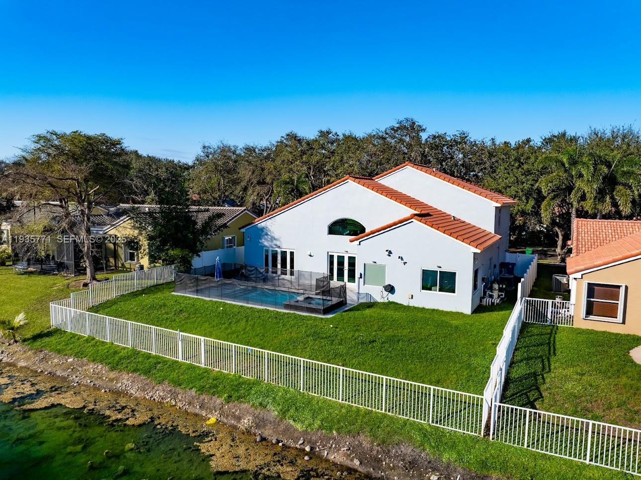 13020 Southwest 17th Court Miramar, FL 33027 - Photo 62 of 78 a view of a house with a big yard and large trees
