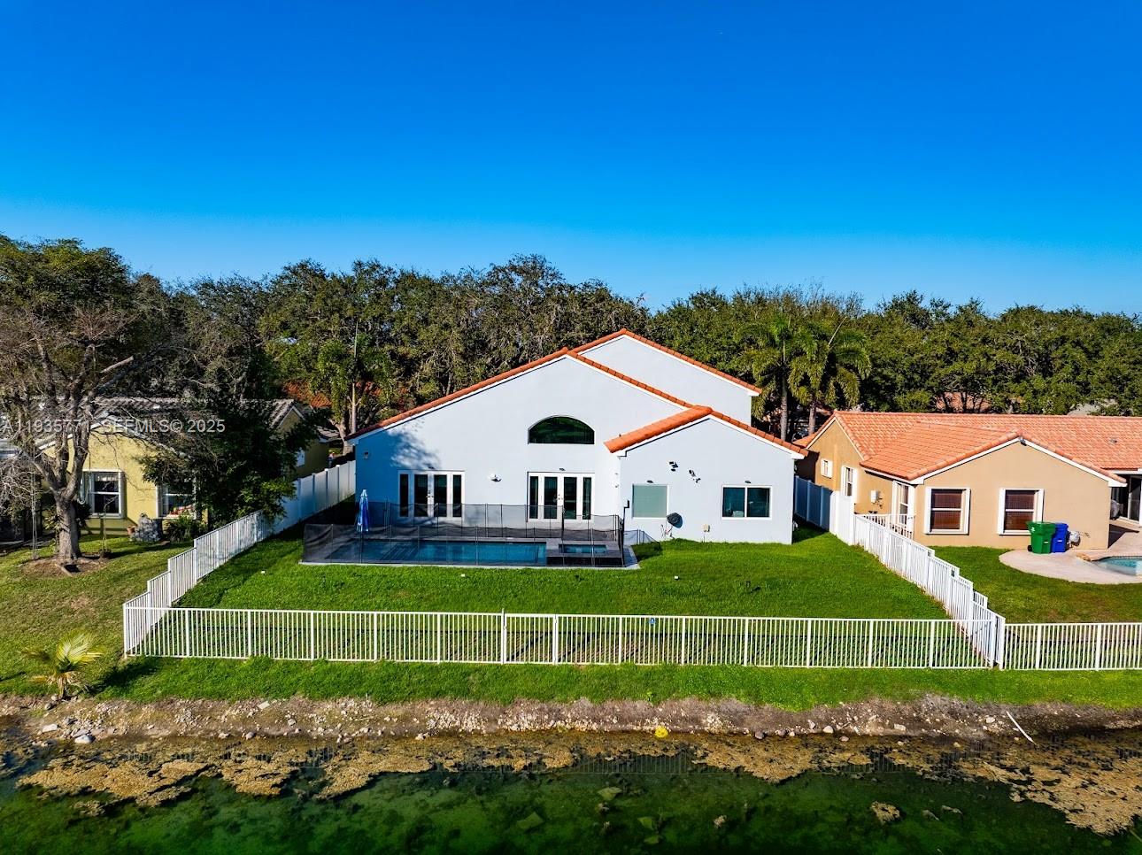 13020 Southwest 17th Court Miramar, FL 33027 - Photo 67 of 78 a front view of a house with a garden and trees