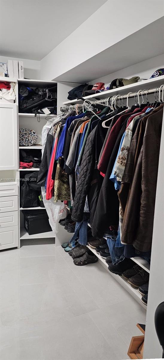 13020 Southwest 17th Court Miramar, FL 33027 - Photo 75 of 78 a view of walk in closet with clothes and shoes