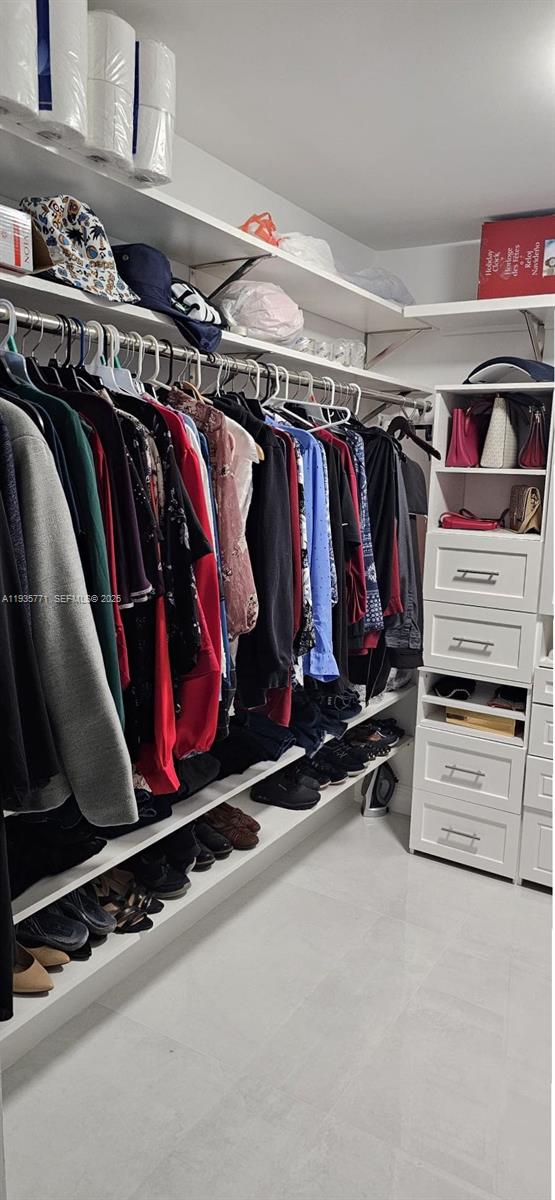 13020 Southwest 17th Court Miramar, FL 33027 - Photo 76 of 78 a view of walk in closet with clothes