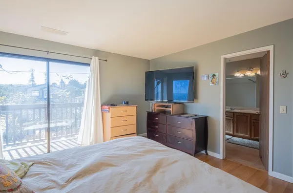 a view of an empty room with furniture and entryway