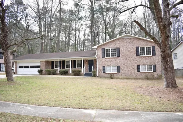 a front view of a house with a garden