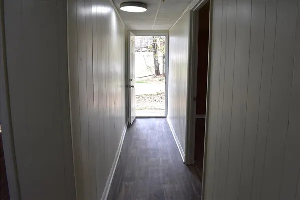 a view of a hallway with wooden floor