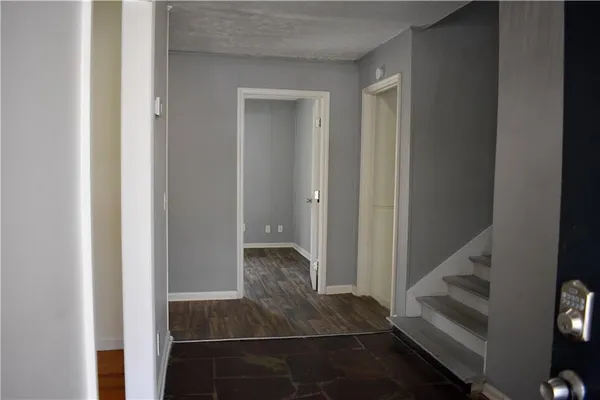 a view of entryway and hall with wooden floor