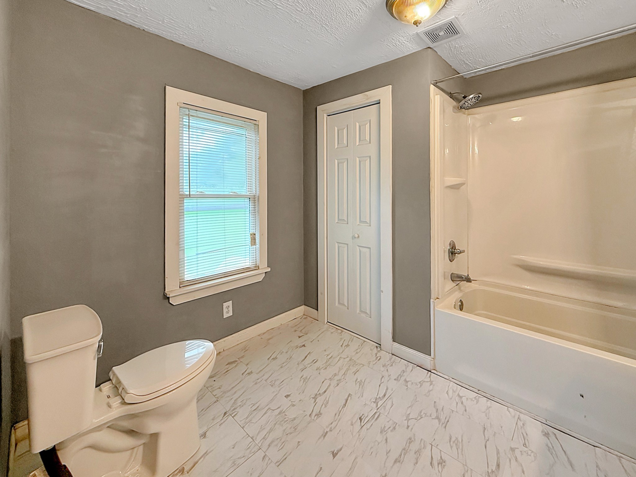 63 West Greendale Street Corbin, KY 40701 - Photo 11 of 24 a bathroom with a toilet sink and shower