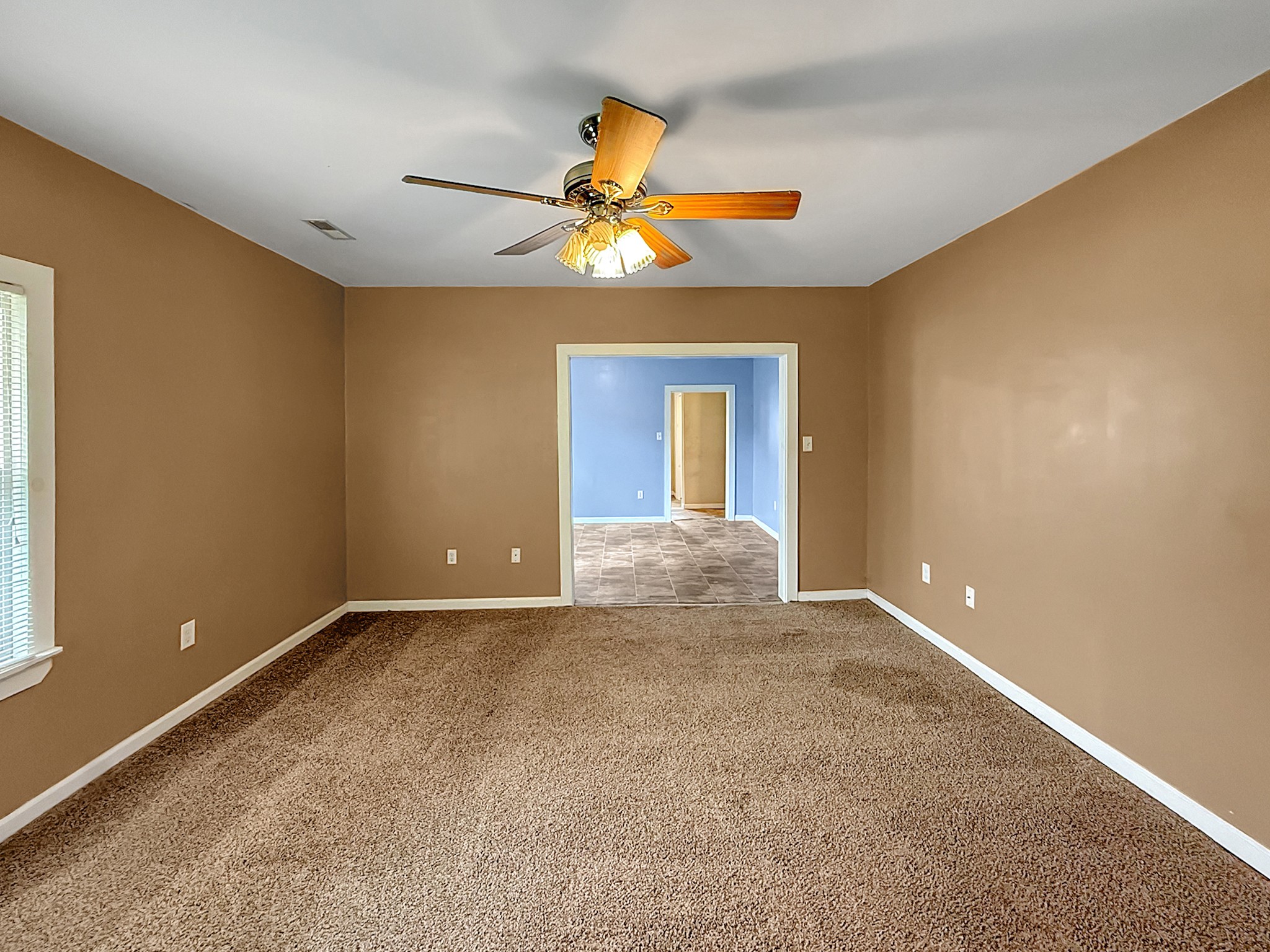 63 West Greendale Street Corbin, KY 40701 - Photo 4 of 24 a view of an empty room with window and chandelier fan