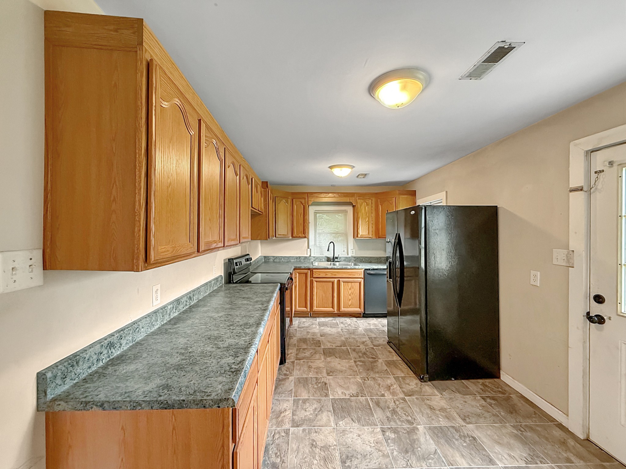 63 West Greendale Street Corbin, KY 40701 - Photo 5 of 24 a kitchen with stainless steel appliances granite countertop a refrigerator a stove and a sink with granite countertops