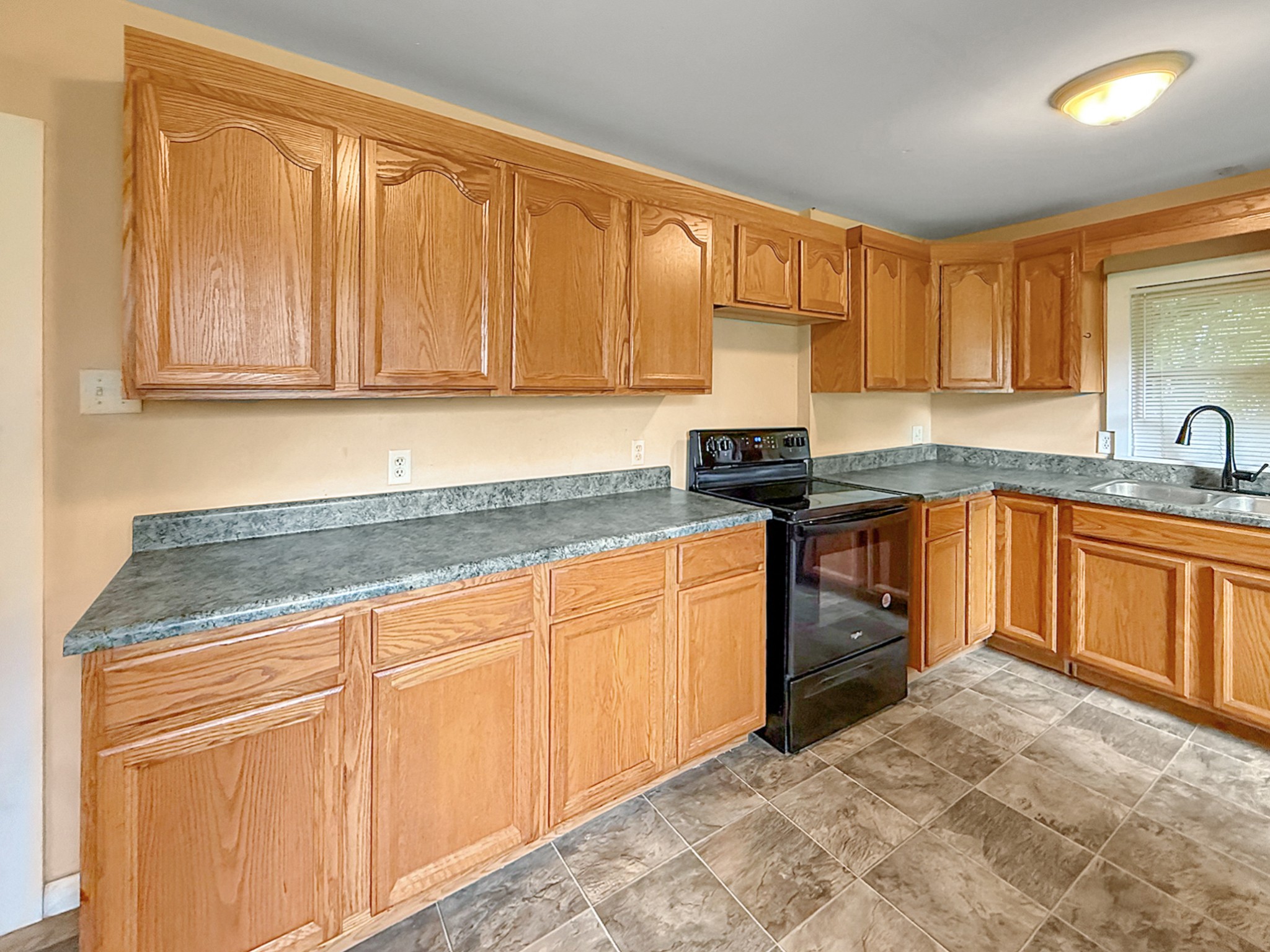 63 West Greendale Street Corbin, KY 40701 - Photo 6 of 24 a kitchen with stainless steel appliances granite countertop a sink stove and cabinets