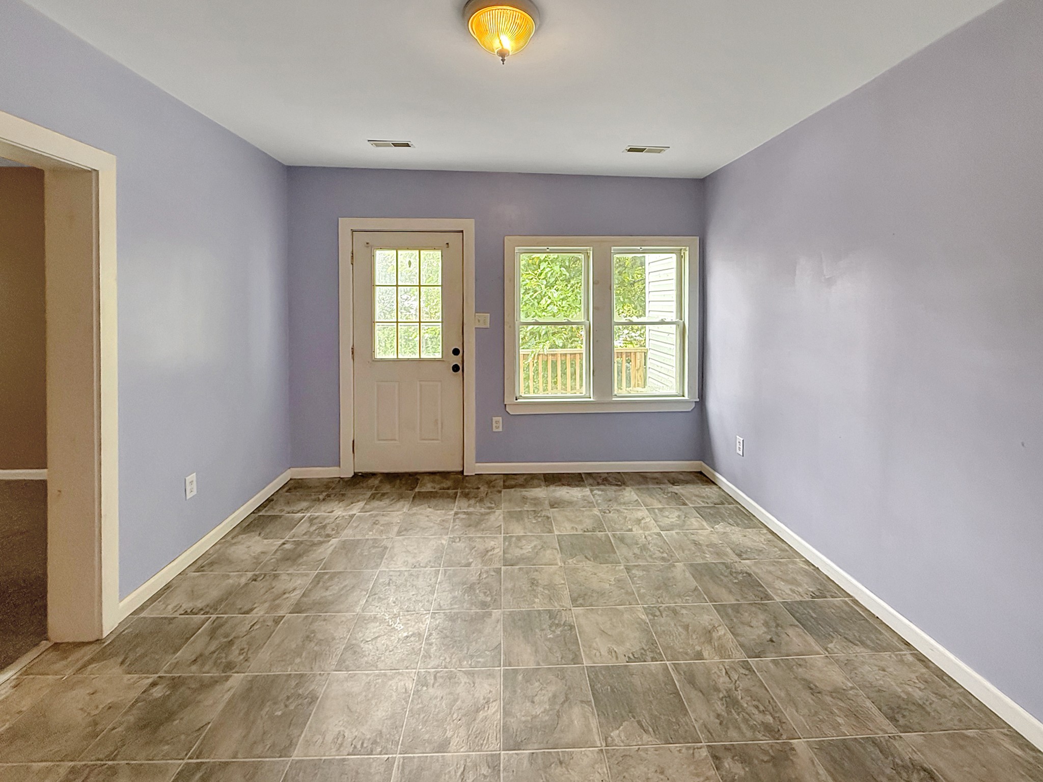 63 West Greendale Street Corbin, KY 40701 - Photo 9 of 24 a view of an empty room with window and chandelier fan