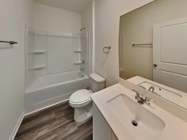 a bathroom with a toilet and a bath tub
