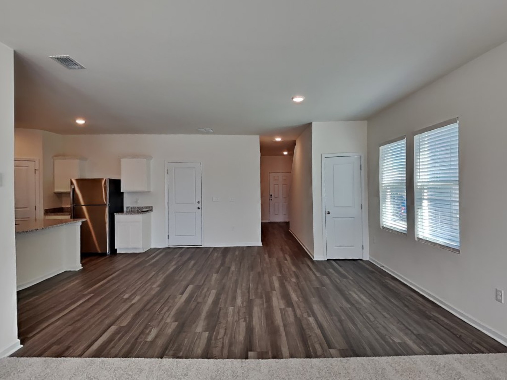 305 Nasturtium Way La Vergne, TN 37086 - Photo 3 of 22 a view of an empty room with wooden floor and a window