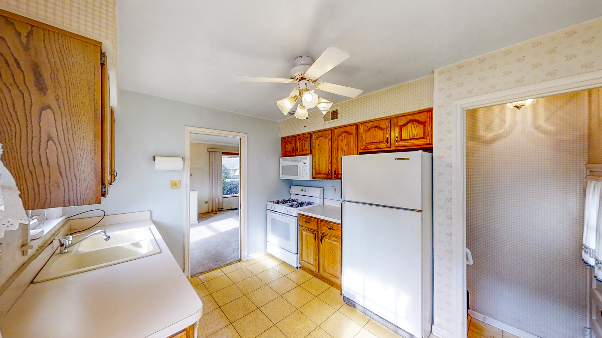 1933 South Crescent Avenue Park Ridge, IL 60068 - Photo 7 of 23 a kitchen with stainless steel appliances granite countertop a refrigerator a oven a sink dishwasher and a dining table with wooden floor