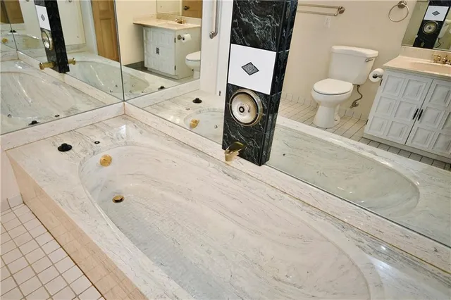 a bathroom with a toilet sink and mirror