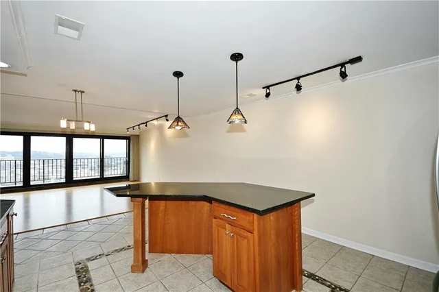 a hallway with a large window and chandelier
