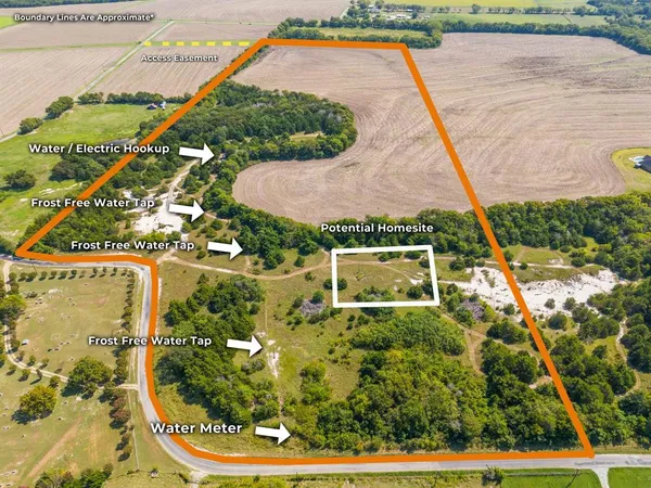 an aerial view of a house with a yard and potted plants